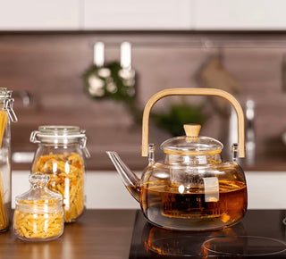 Glass teapot with wooden handle on kitchen countertop